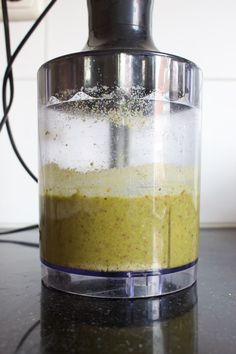 a blender filled with liquid on top of a counter