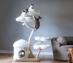 a cat tree with cats on top of it