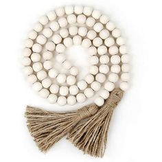 white beads with tassels on a string and a brown tasseled cord