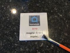 a close up of a small business card with a toothbrush on top of it