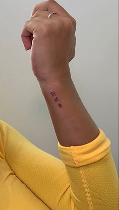 a woman with a small tattoo on her wrist