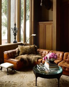 a living room filled with furniture and lots of windows