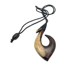 Handmade Warrior's Hawaiian Makau (Fish Hook Pendant) with Polynesian engravings. Hand carved from Black Rosewood and features 4 teeth carved from bone. This Fish Hook was designed in Hawai'i and one of Makana Hut's latest design. Hawaiian Fish Hook (Makau in Hawaiian): Symbolizes giving a person Prosperity, Strength and Good Luck, Also a great respect for the Sea Size: Approximately 3-3/4 inch tall x 1-1/2 inches wide Engraving on Hook Includes adjustable cord Material: Black Rosewood and Bone Maori Hook, Hawaiian Fish, Wood Jewelery, Fish Hook Necklace, Hook Necklace, Bone Art, Fish Hooks, Mini Craft, Brown Tone