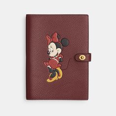 Beloved Disney characters meet iconic Coach design in this special collection starring the one-and-only Mickey Mouse and friends. Perfect for the doodlers ideators diarists note-takers and list-makers this distinctive notebook keeps you on point. Secured with our iconic turnlock closure the regenerative leather style features the endearing Minnie Mouse striking a pose. Crafted to last the leather is sourced from farms that use regenerative agricultural practices – those that help maintain and rejuvenate grasslands increase biological diversity soil health and productivity and could lead to increased carbon absorption. | Disney X Coach Notebook In Regenerative Leather With Minnie Mouse - Women's - Brass/wine Multi Coach Notebook, Biological Diversity, Coach Disney, Agricultural Practices, Mini Notebooks, Backpack Charm, Soil Health, Large Wallet, Mickey Mouse And Friends