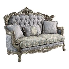 an ornately decorated couch with pillows on it's back and armrests