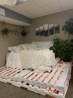 a bed made out of pallets and some plants