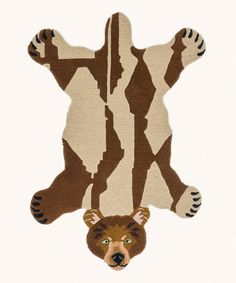 a brown and white bear rug on top of a white floor with one paw up