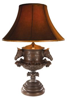 an ornate lamp with a brown shade on it