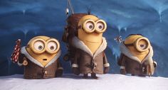 three minions from despicables are standing in the snow