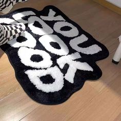 a black and white rug with the words do you speak? on it, next to a pair of high heeled shoes