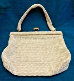 VTG Hobnail Buckle Cream Handbag Measurements Bottom- 12" Side- 8" Strap- 6" Simple Corde bead hobnail handbag. Cream eggshell in color, does have some problem areas. The handle underneath has a hole. Beads are in good condition. Lining inside off white, two pockets. THIS IS A VINTAGE ITEM - it is SOLD AS IS - Vintage items may have been used, and may have signs of wear or storage wear such as stains, marks, loose threads and/or beads, tarnish to metal parts, etc. Please see photos and ask quest Vintage Cream Shoulder Bag For Vacation, Vintage Cream Bags, Vintage Handmade Cream Crochet Bag, Cheap Vintage Bags With Gold-tone Hardware, Vintage Beaded Beige Bags, Burlap Bag, Purses And Handbags, Reusable Tote Bags, Buckle