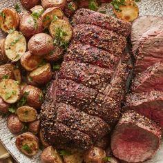 a steak and potatoes on a plate with parsley sprinkled in seasoning