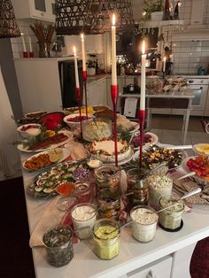 a table filled with lots of food and candles