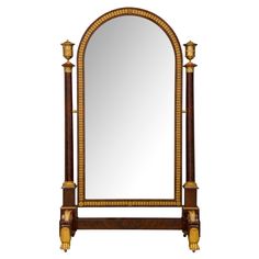 a large mirror sitting on top of a wooden stand with gold trimmings and columns