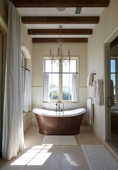 a large bathroom with a tub, sink and shower in the middle of it's walls