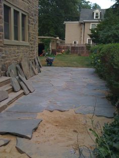 a stone walkway in front of a house