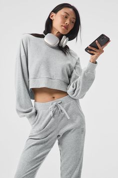 Stay seriously comfy from studio to street to lounge. The Muse Hoodie is made with a soft ribbed knit and has a relaxed, cropped silhouette and slits at sides. Pair it with the matching sweatpant to master off-duty. Casual Alo Yoga Tops For Loungewear, Alo Yoga Casual Loungewear Top, Fall Lounging Sweats Sportswear, Ribbed Cropped Sweater For Fall Loungewear, Relaxed Sweats For Winter Lounging, Relaxed Sweats For Lounging In Winter, Athleisure Hoodie With Ribbed Cuffs For Lounging, Comfy Winter Loungewear Activewear, Cozy Ribbed Cropped Sweater For Loungewear