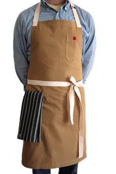 a man wearing an apron and hat