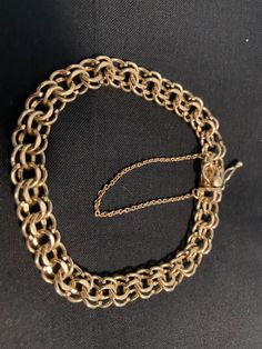 14k yellow gold double link bracelet with box type clasp and safety chain. It is approximately 1/4” wide. It weighs 15g or 1/2 oz. It is approximately 7 1/4” wide. The box type clasp and safety chain provide for safe wearing. 14k Gold Oval Link Jewelry With Box Clasp, Yellow Gold Link Charm Bracelet With Curb Chain, Yellow Gold Charm Bracelet With Curb Link Chain, Vintage 14k Gold Chain Link Bracelet, Vintage Yellow Gold Chain Link Bracelet, Heirloom Gold Jewelry With Box Clasp, Vintage Yellow Gold Chain Bracelet, Yellow Gold Chain Bracelet With Box Clasp, Vintage 14k Gold Link Bracelet