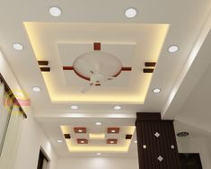 the ceiling in this room is decorated with white and brown accents, along with recessed lighting