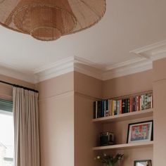 a living room filled with furniture and bookshelves in front of a large window