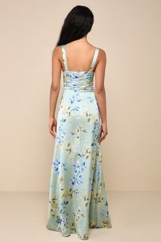 the back of a woman wearing a blue and green floral print dress with spaghetti straps