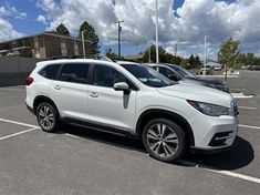 a white subarunt parked in a parking lot