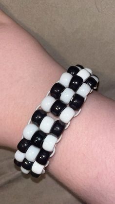 a person wearing a black and white bracelet