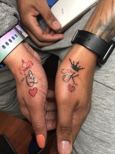 two people with matching tattoos on their hands