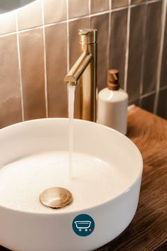 a bathroom sink with a faucet and soap dispenser