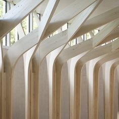 the inside of a building with wooden beams