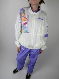 Vintage 90s Diadora sports set, nylon tracksuit, lilac and white color Size L (check the measurements carefully) Jacket measurements: Length from collar to cuff: 75 cm Width from armpit to armpit: 65 cm Length: 65cm Pants measurements: Waist: Elastic from 34cm to 52cm (It has laces to tighten them) Horse: 31 cm Thigh width: 33 cm Length: 100cm The model is 164 cm tall and usually wears a size S Condition: PERFECT - No signs of wear Our garments are all vintage and second hand. Any signs of wear 90s Style White Windbreaker For Spring, White Retro Windbreaker For Spring, Retro White Windbreaker For Spring, Retro White Spring Windbreaker, 90s White Windbreaker For Sports, Vintage Style Long Sleeve Nylon Track Jacket, Vintage Nylon Track Jacket For Streetwear, 1980s Track Suit, Vintage Cotton Hooded Track Jacket