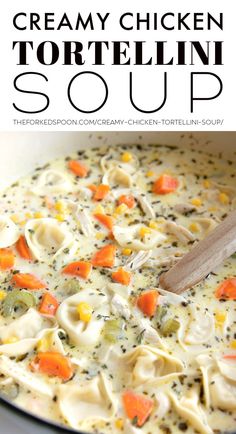 creamy chicken tortellini soup in a pot with a wooden spoon