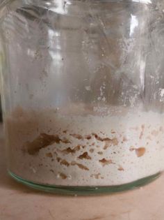 a glass jar filled with liquid sitting on top of a table