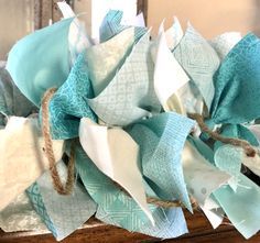 a bunch of blue and white fabric on top of a wooden table