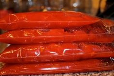 three bags of hotdogs stacked on top of each other in front of a counter