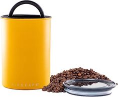 a yellow coffee canister next to some coffee beans