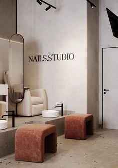 the interior of a nail studio with chairs and stools in front of a mirror