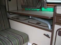 the interior of an rv with green lights