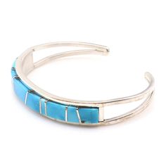 Experience the exquisite craftsmanship of Navaho artist Sam Arviso with this handcrafted Turquoise channel inlay bracelet. Measuring 5 1/4" from tip to tip with a 1" opening, this bracelet is expertly crafted and not easily adjustable. Its sleek 3/8" width and weight of approximately 17.4 grams make it a stunning addition to any jewelry collection. Adjustable Blue Inlay Cuff Bracelet, Adjustable Blue Cuff Bracelet With Inlay, Adjustable Turquoise Inlay Bracelets, Adjustable Turquoise Bracelet With Inlay, Make It, Jewelry Collection, Sleek, Thing 1, Turquoise