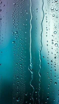 water drops on the glass with blue and purple background