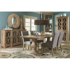 a dining room table and chairs with blue walls