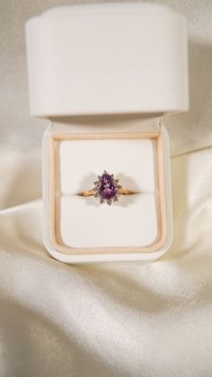 * Ring Material: Amethyst, Diamond, 14K Yellow Gold * Ring Dimensions: 11.8x14.3MM Top Design, 1.5MM Tapering Band * Size: 6.5 * Stone Weight & sizes: Amethyst - 1.70ct, Diamond - 0.20ct * Overall weight: 3.8g Purple Rose Cut Diamond Rings In 14k Gold, Purple 14k Gold Ring With Rose Cut Diamonds, Purple 14k Gold Rings With Rose Cut Diamonds, Wedding Yellow Gold Amethyst Ring With Halo Setting, 14k Yellow Gold Amethyst Ring With Halo Setting, Yellow Gold Amethyst Ring With Halo Setting For Promise, 14k Gold Pear Shaped Ring With Prong Setting, Pear-shaped 14k Gold Ring With Prong Setting, Formal Amethyst Rings With Halo Detail