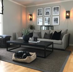 a living room filled with furniture and pictures on the wall above it's coffee table