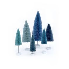 five different colored trees in white vases on top of each other, one is blue and the other is green