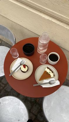 there is a piece of pie on the table with two cups of coffee next to it