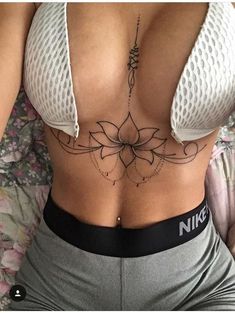 a woman's stomach with tattoos on it and the bottom part of her body