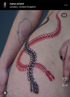 a woman's thigh with a snake tattoo on it and the words london united kingdom