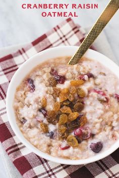 a bowl of oatmeal with raisins and cranberries