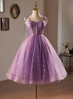 Metamorphose into the belle of the ball in this stunning lavender homecoming dress. Impeccably crafted from layers of light-catching tulle, this dress shines with embedded glitter and delicate starry patterns throughout. The bodice is expertly designed with corset-like detailing, enhancing your silhouette, while the flowing skirt invites twirls and dances under the homecoming lights. Adjustable straps ensure a perfect fit, making you feel as fabulous as you look. This dressromantic allure is heightened by its dreamy color and the subtle glimmers that suggest a galaxy of possibilities. Whether you're posing for pictures or dancing the night away, this dress is your ally for an unforgettable homecoming experience. Lavender Tulle Prom Dress, Short Sleeve Prom Dress, Lavender Homecoming Dress, Tea Length Homecoming Dresses, Purple Prom Dress Short, Short Sleeve Prom Dresses, Sleeve Prom Dress, Purple Prom, Purple Prom Dress